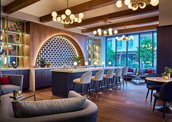 The lobby with a bar and tables and chairs